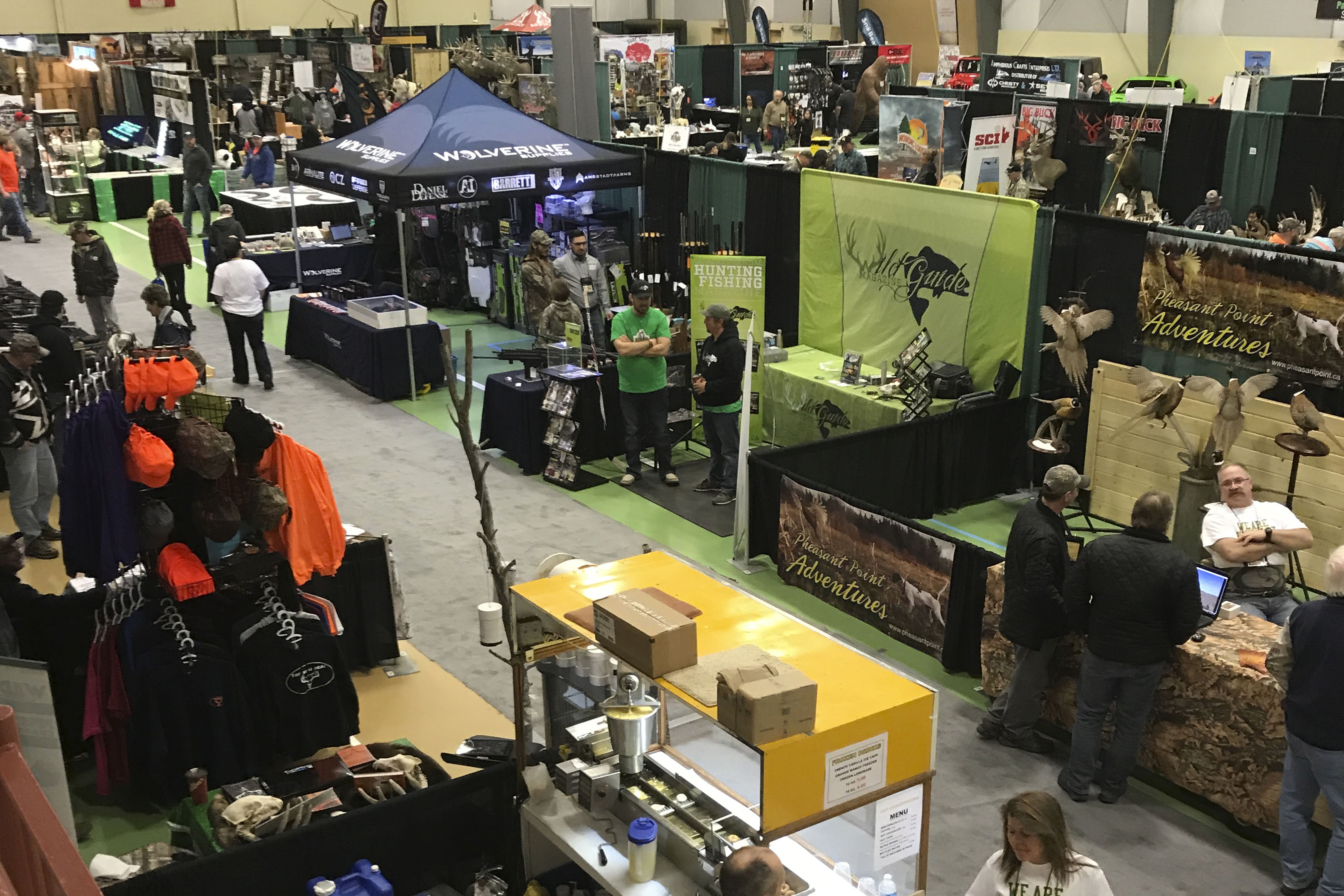 people at booths in convention centre